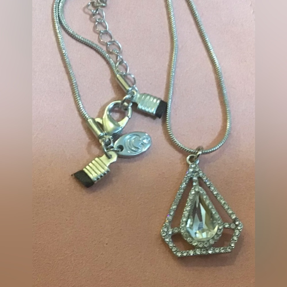 Charming Charlie: silver 12”plated triangle/pear shaped/teardrop shaped pendant.